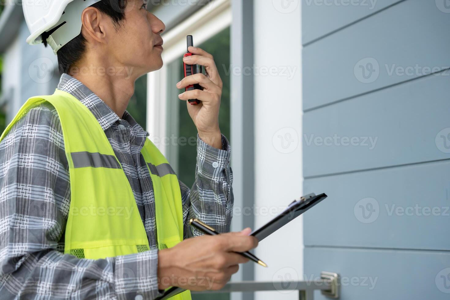 inspecting construction and quality assurance new house using a checklist. Engineers or architects or contactor work to build the house before handing it over to the homeowner photo