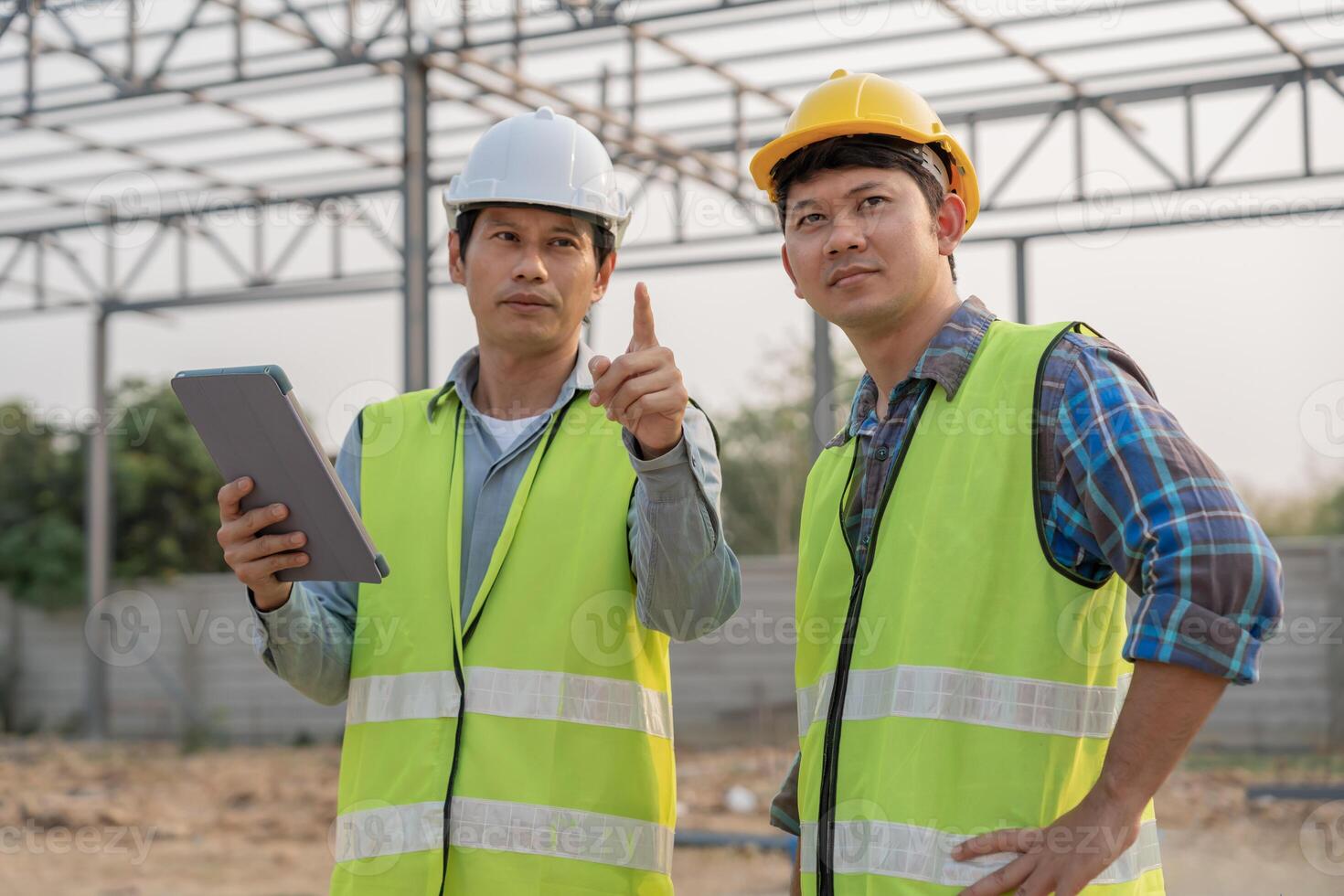 inspector or engineer is inspecting construction and quality assurance new house using a tablet. Engineers or architects or contactor work to build the house before handing it over to the homeowner., photo
