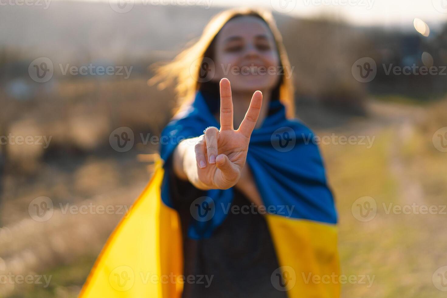 Cheerful ukrainian girl that shows a sign of peace or victory. photo