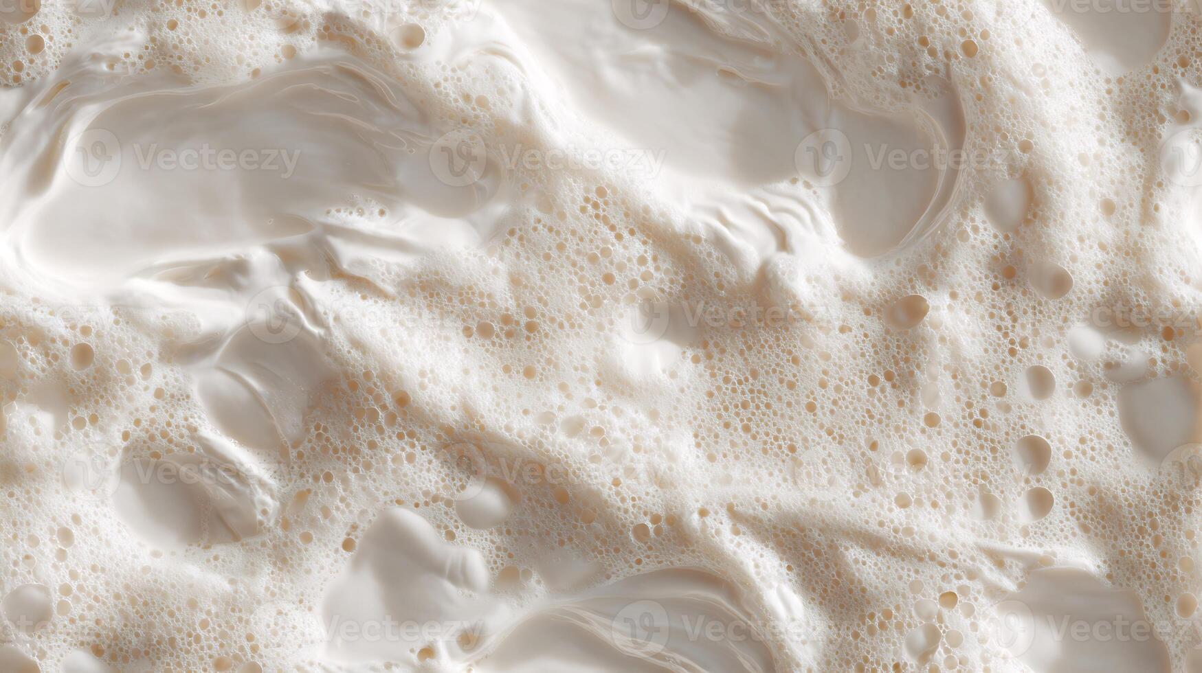 A close-up view of creamy, frothy milk foam, an abstract background texture. Seamless tile. photo