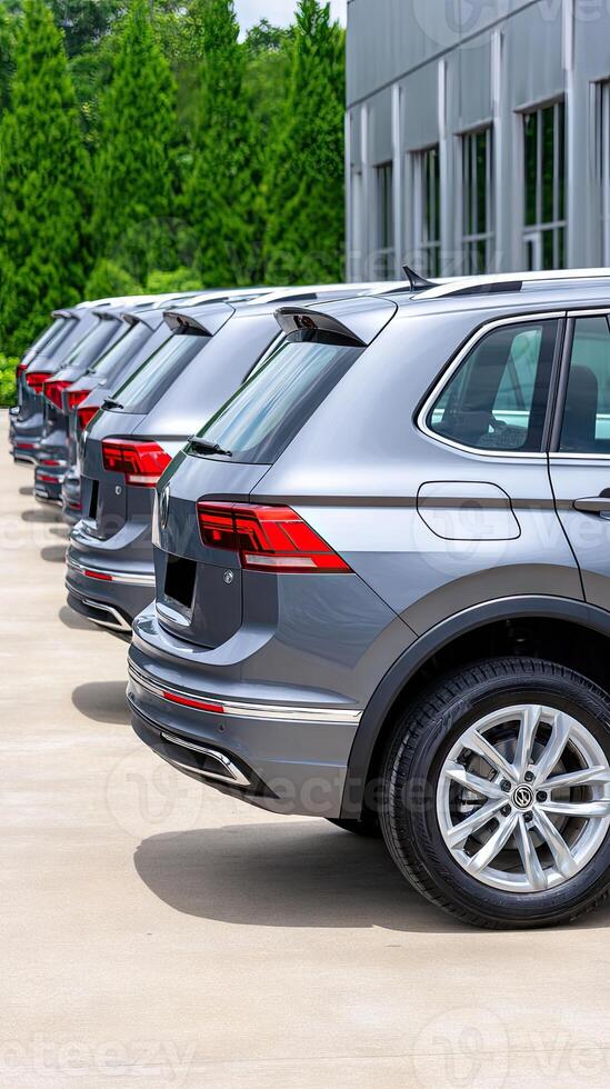 A row of silver suvs parked in front of a building photo