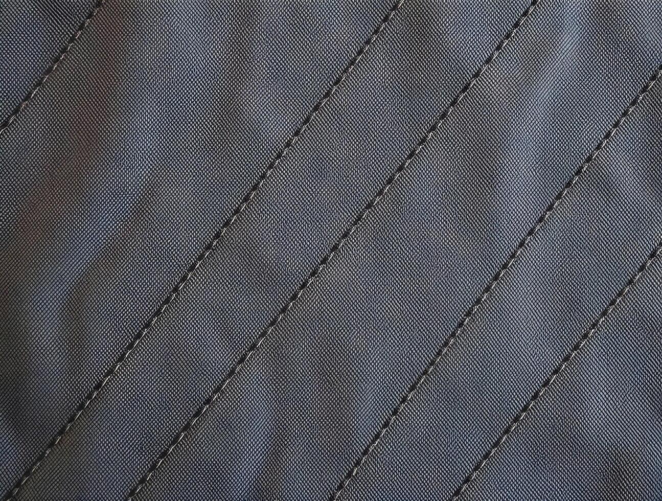 Dark Gray Fabric Texture CloseUp Detailed View of Woven Material with Diagonal Stitching for Design Projects photo