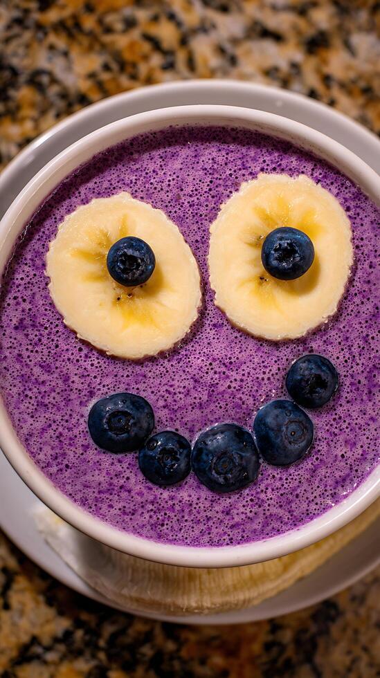 Cheerful Blueberry Smoothie with Banana Eyes and Grinning Mouth. photo