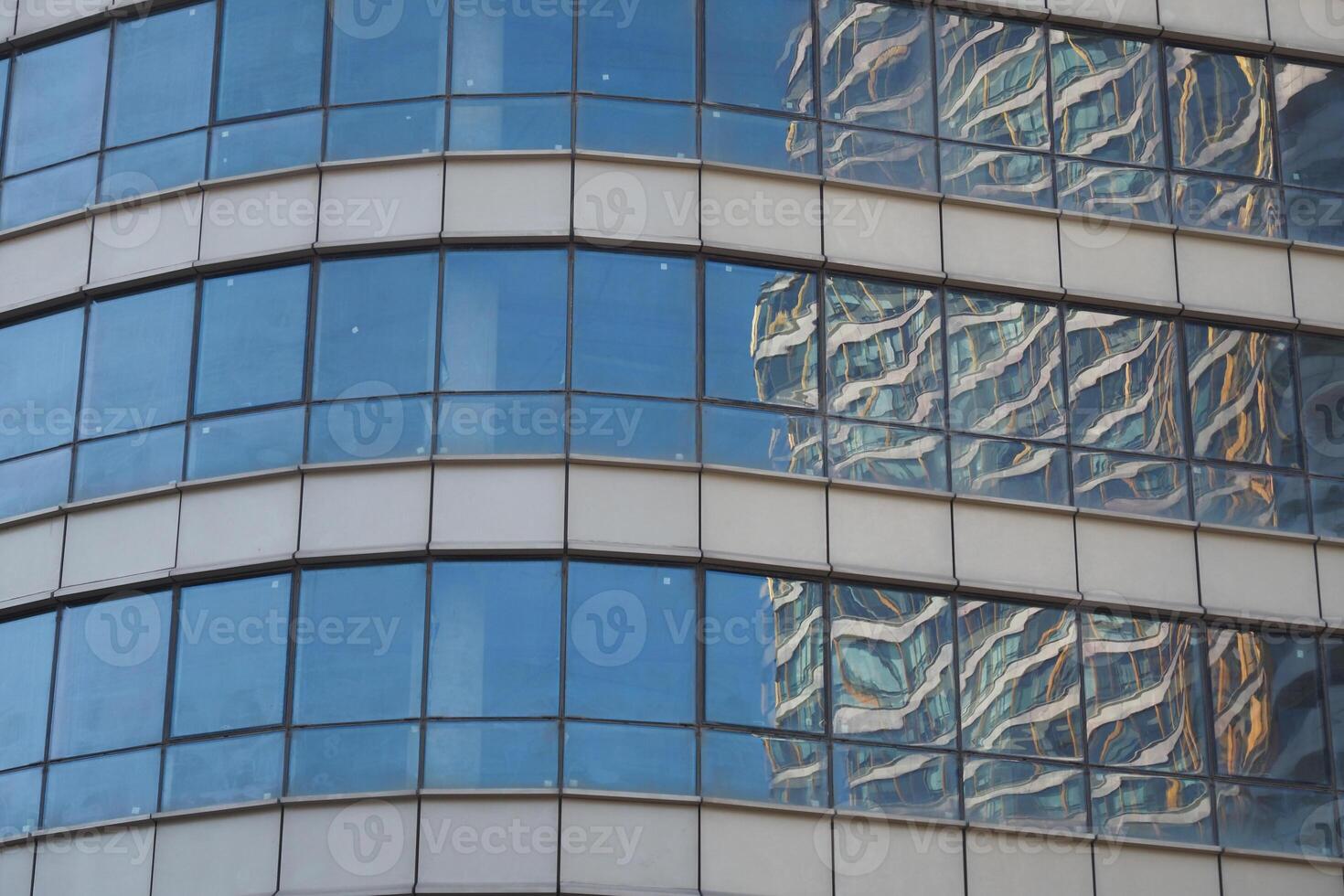Reflective glass building shows neighboring architecture photo