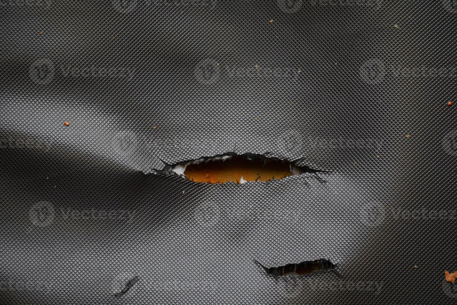 Detailed view of a damaged leather sofa . photo