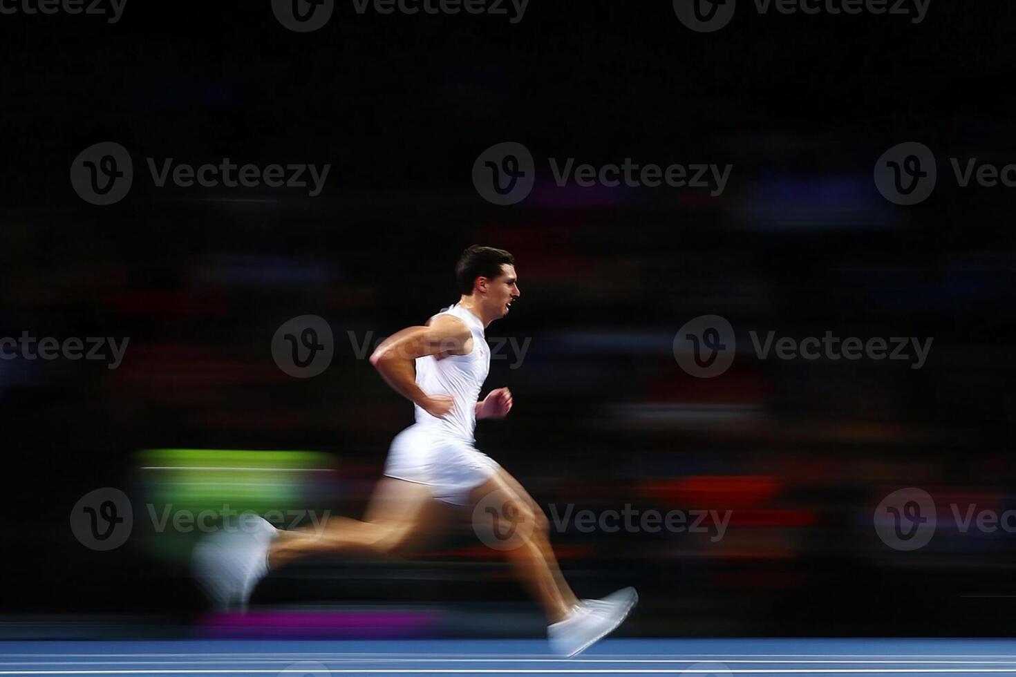A man running on a track in motion photo