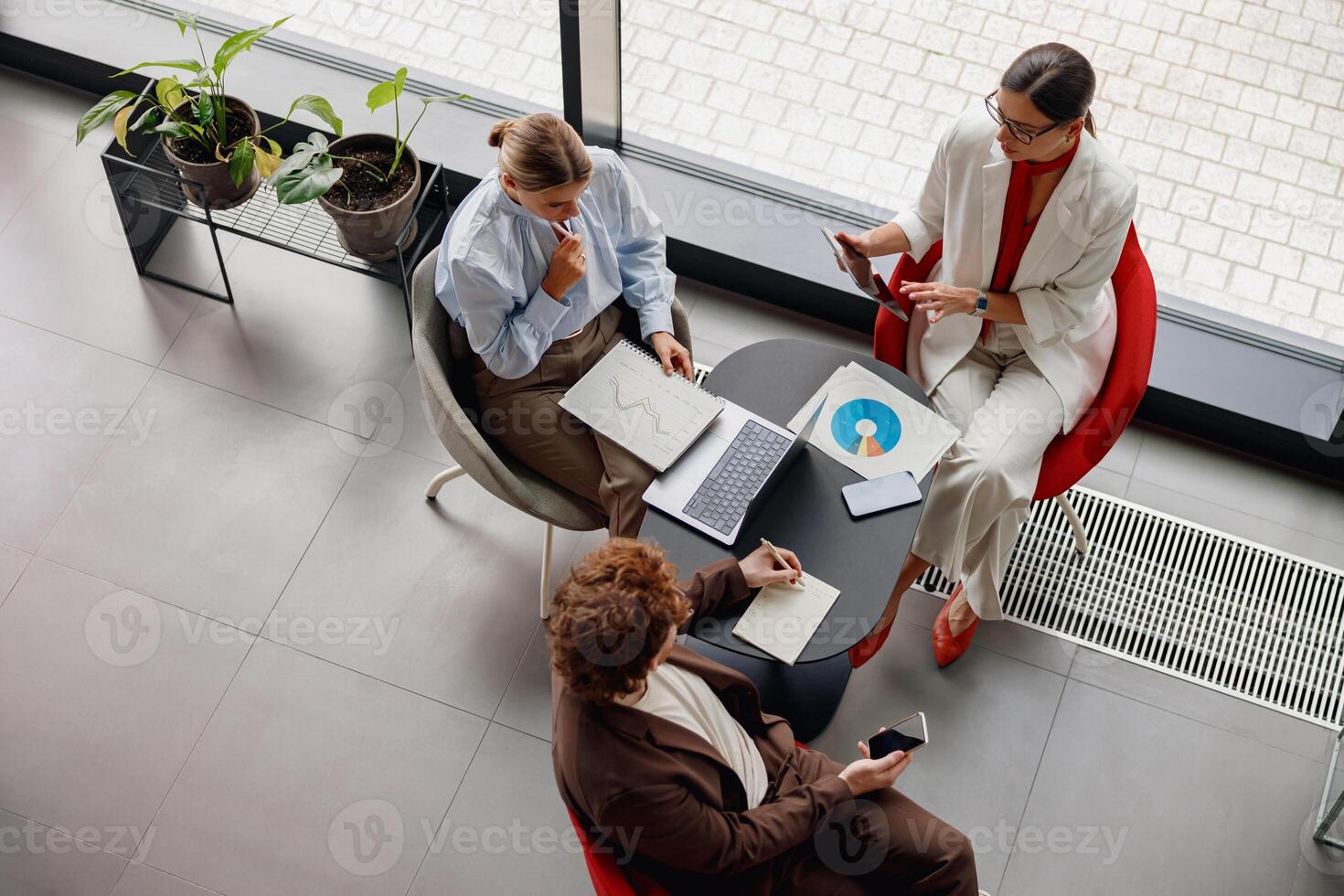 A dynamic business meeting occurs in a modern office setting that fosters creativity and innovation photo