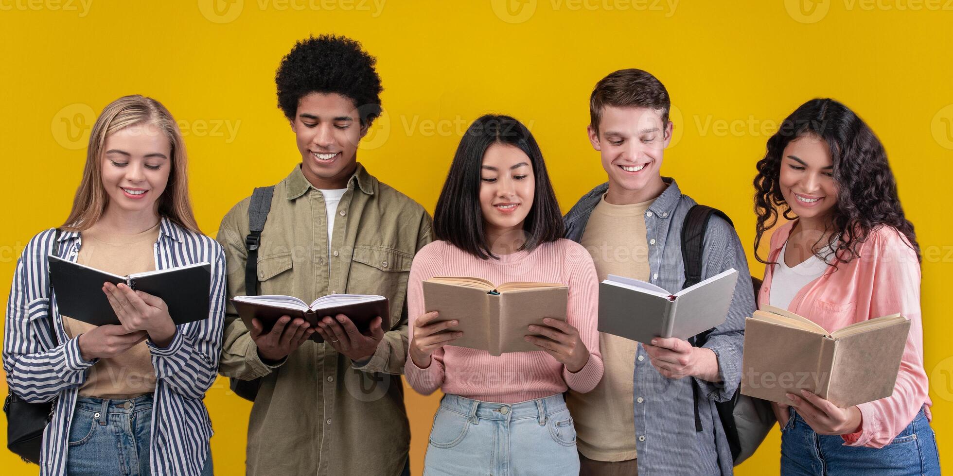 Modern education and teamwork. Happy young university students studying with books in library, group of multiracial people in college read, isolated on orange background, studio shot, empty space photo