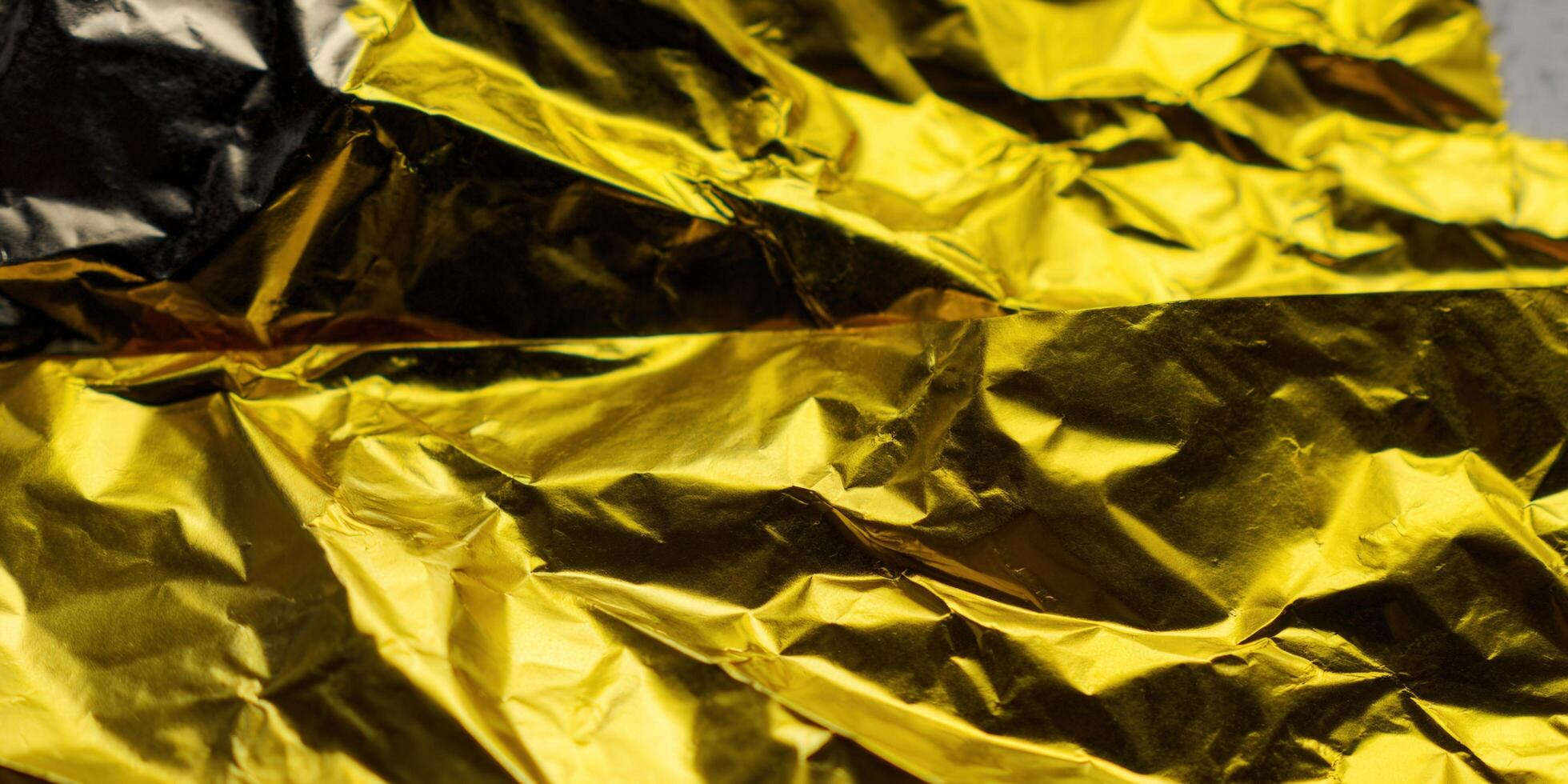 Close-up of crumpled golden foil creating an abstract and textured design with reflective qualities. photo