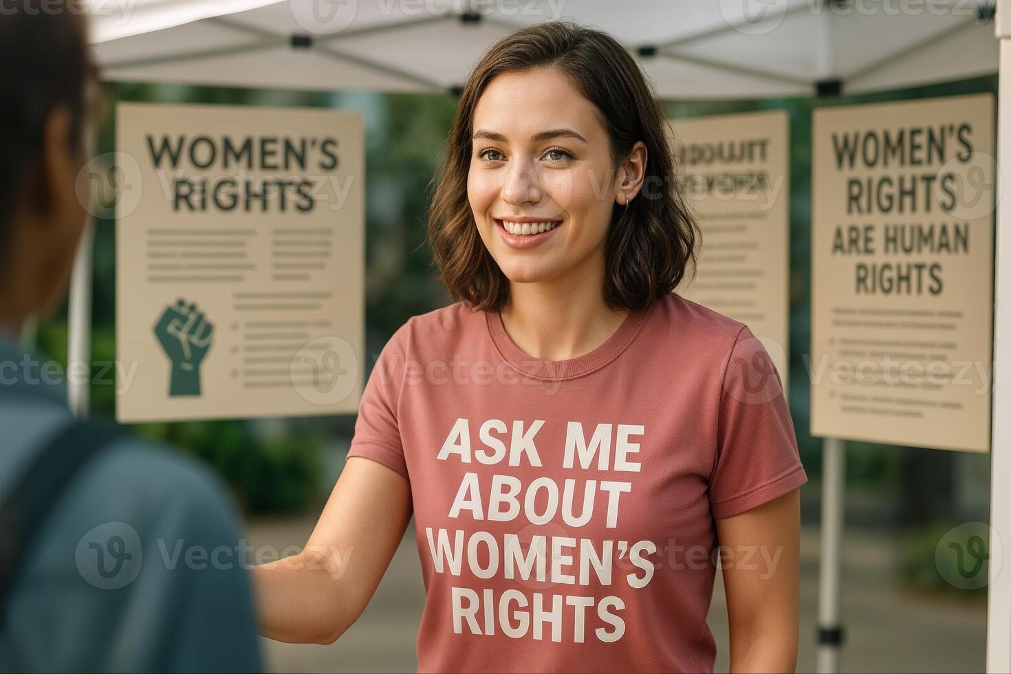 Empowered Advocacy with Young Woman Promoting Women's Rights at Public Outreach Event with Informative Posters photo
