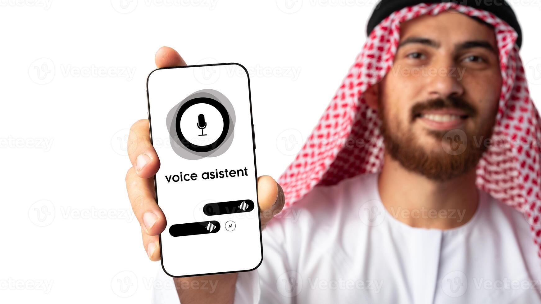 Man in traditional attire holding smartphone with voice assistant interface displayed in a bright setting photo