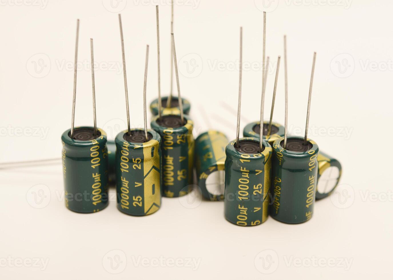 Assorted electrolytic capacitors with various capacitance values. Electronic components for circuit design and energy storage. photo