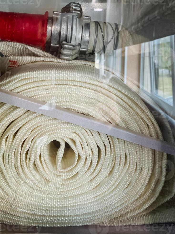 This highquality, durable red fire hose is designed with secure connections, making it fully prepared for emergencies and ensuring maximum safety against flames, smoke, and various hazards photo