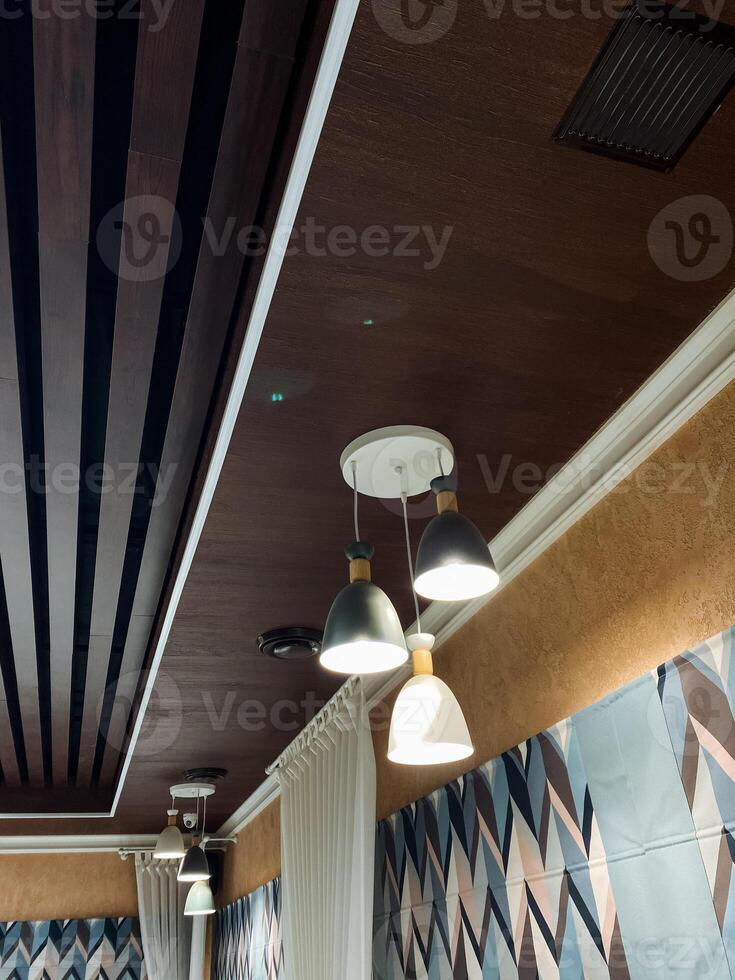 A ceiling adorned with numerous lights elegantly hanging from it, creating a dynamic and visually appealing atmosphere that draws the eye and enhances the rooms overall design photo