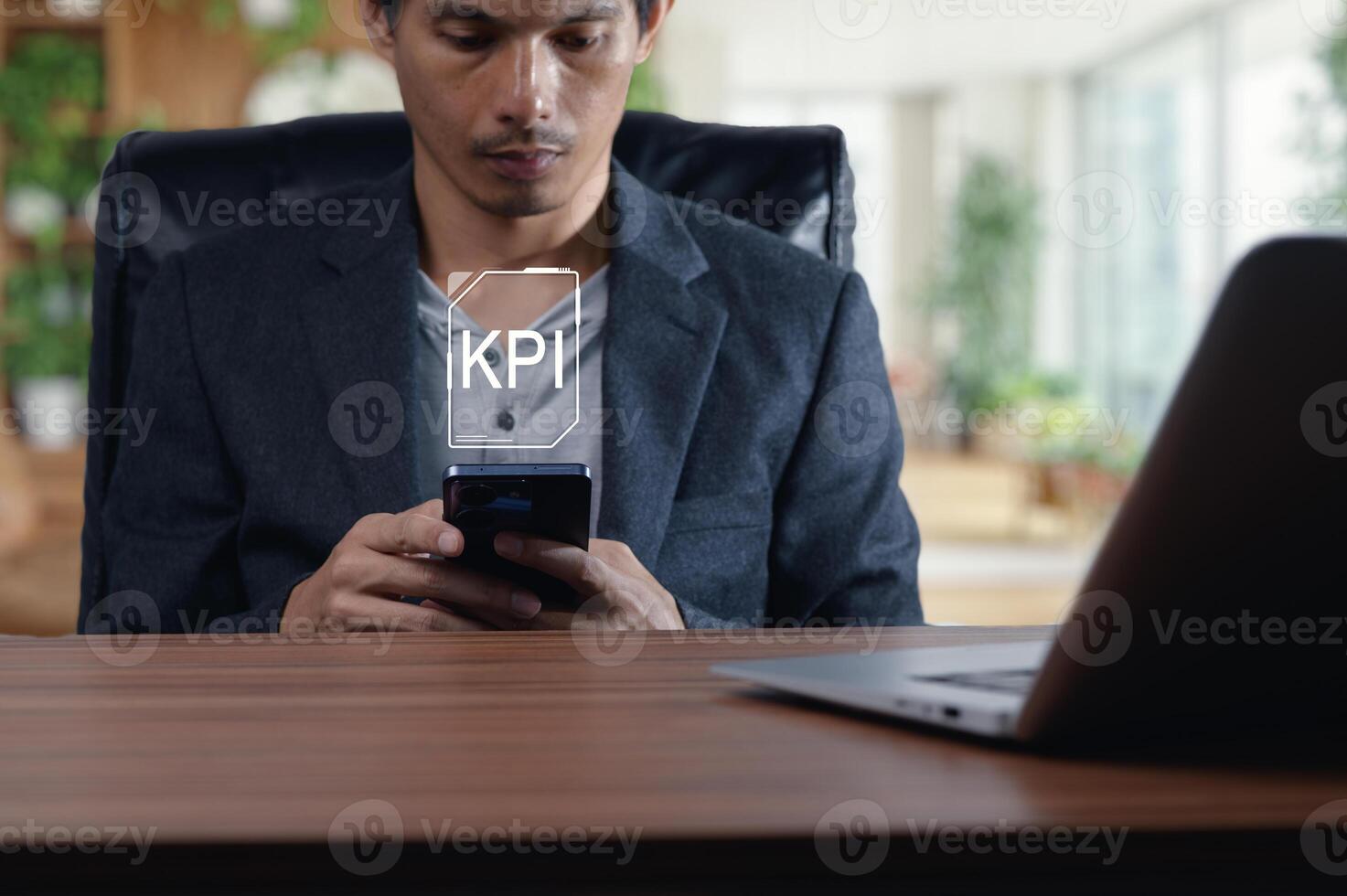 Businessman Analyzing Key Performance Indicators on Mobile Device photo