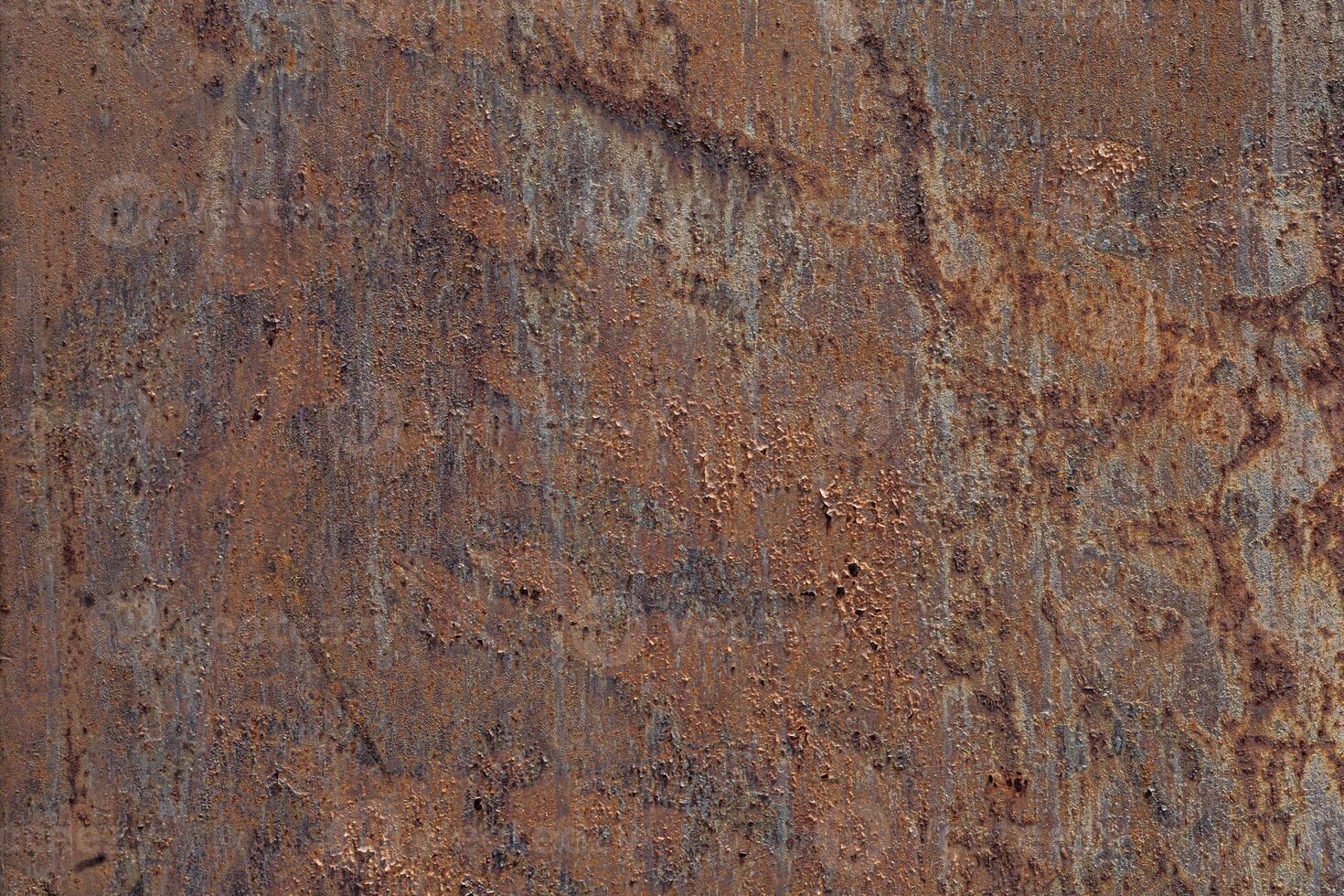 Close up of textured rusty metal surface with shades of brown and orange. The surface shows signs of wear and corrosion, creating an industrial aesthetic. photo