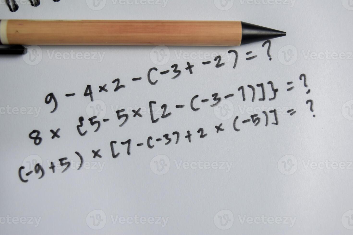 Concept of basic math operation write on book isolated on Wooden Table photo