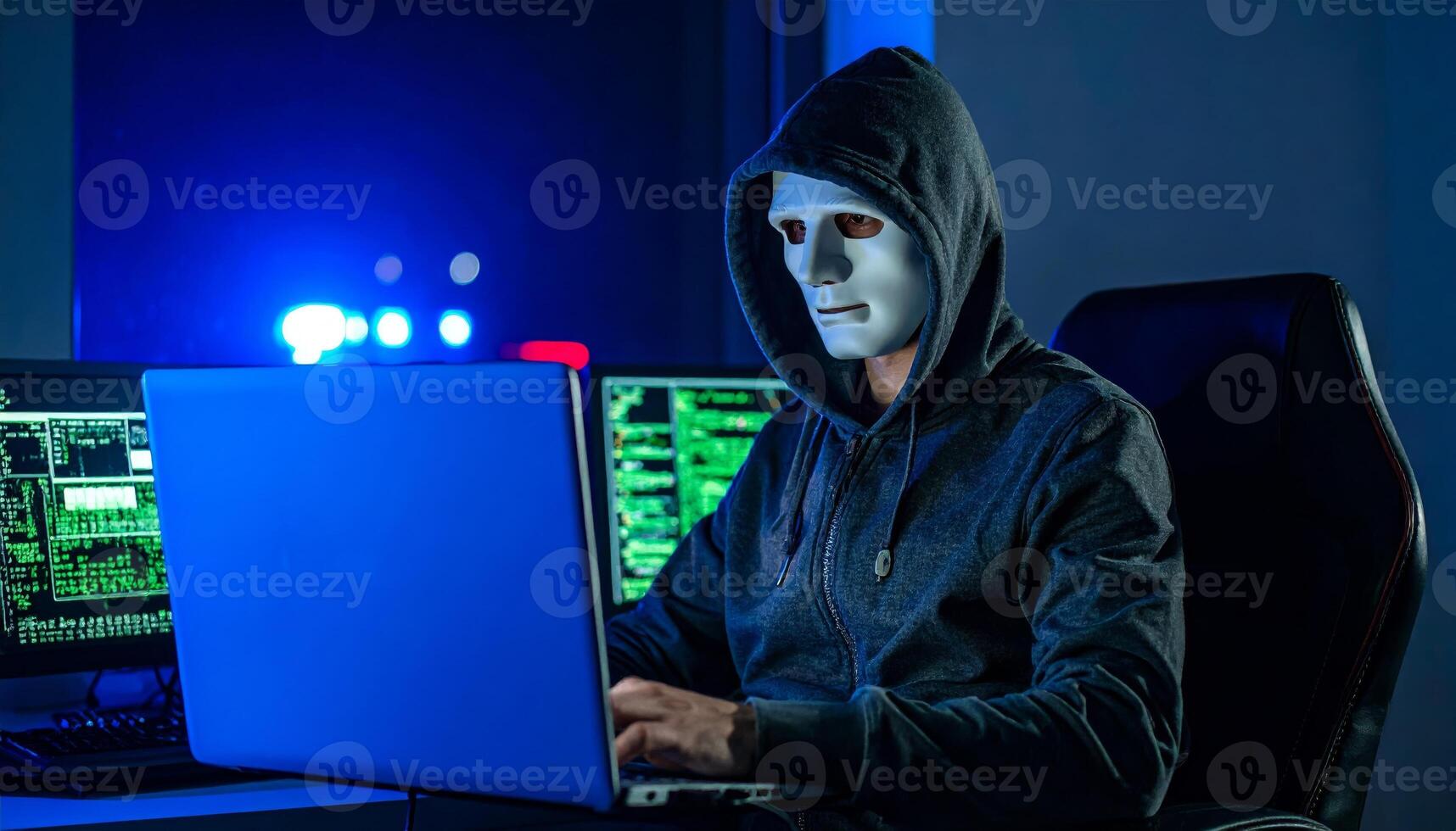 A hacker at their computer with police close by, capturing a tense scene photo