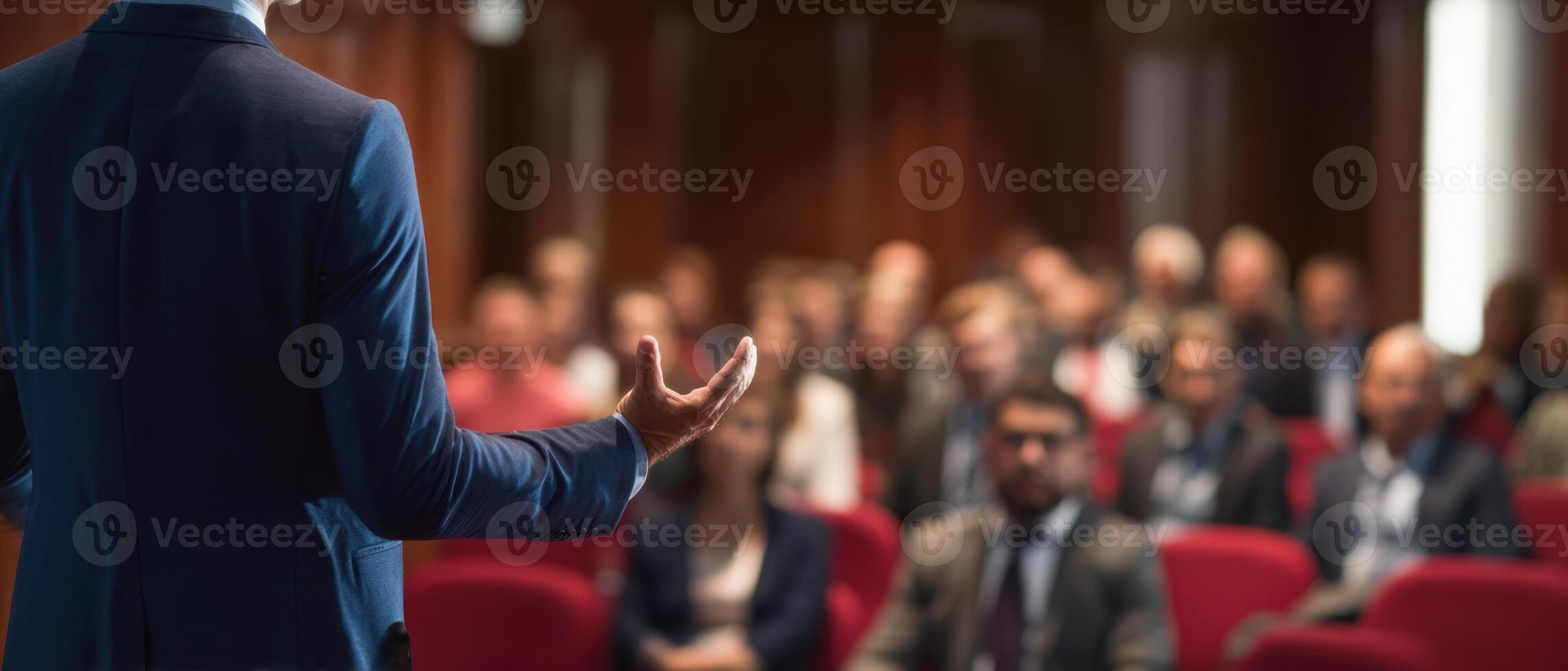 The speaker engaging with a captivated audience in a professional setting. photo