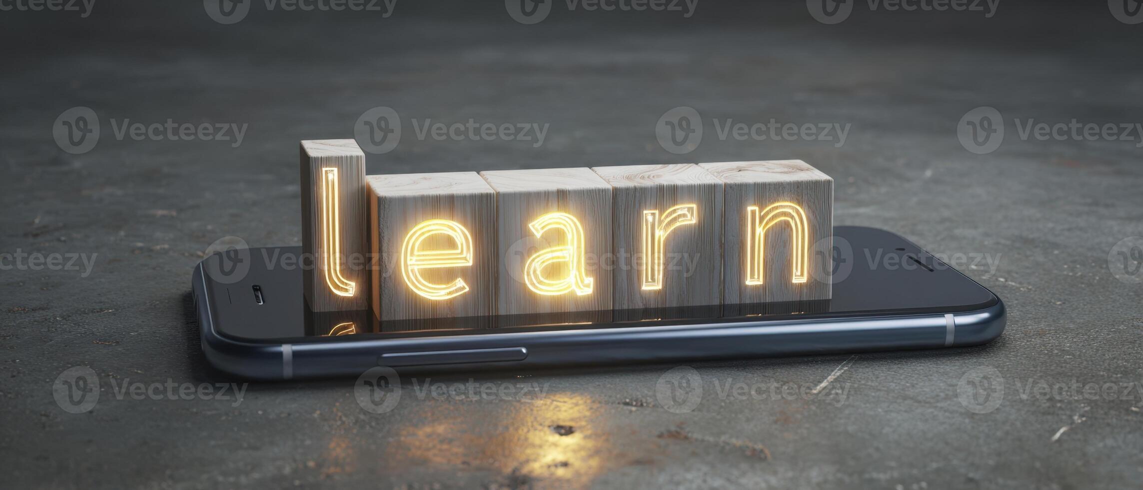 The illuminated wooden letters spelling learn on a smartphone. photo