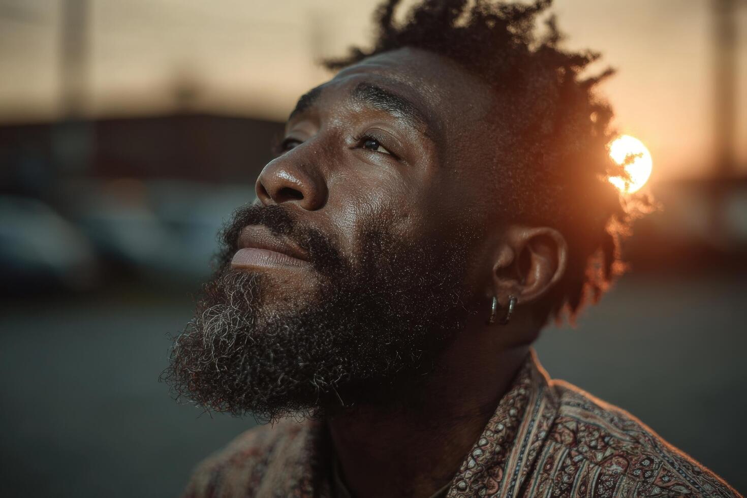 A man with a beard and dreadlocks looking up photo