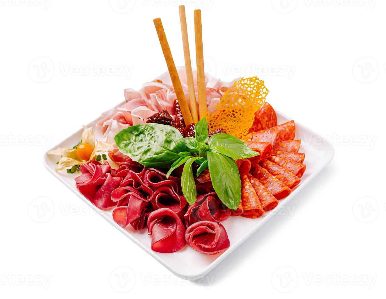 A beautifully arranged charcuterie platter displays various cured meats, crispy breadsticks, and fresh herbs, perfect for entertaining guests during a gathering or celebration. photo