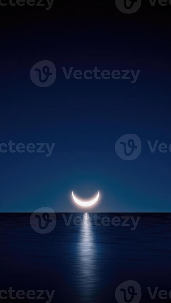 A glowing crescent moon reflects on the calm ocean surface under a deep blue night sky, creating a mystical and serene atmosphere. . photo