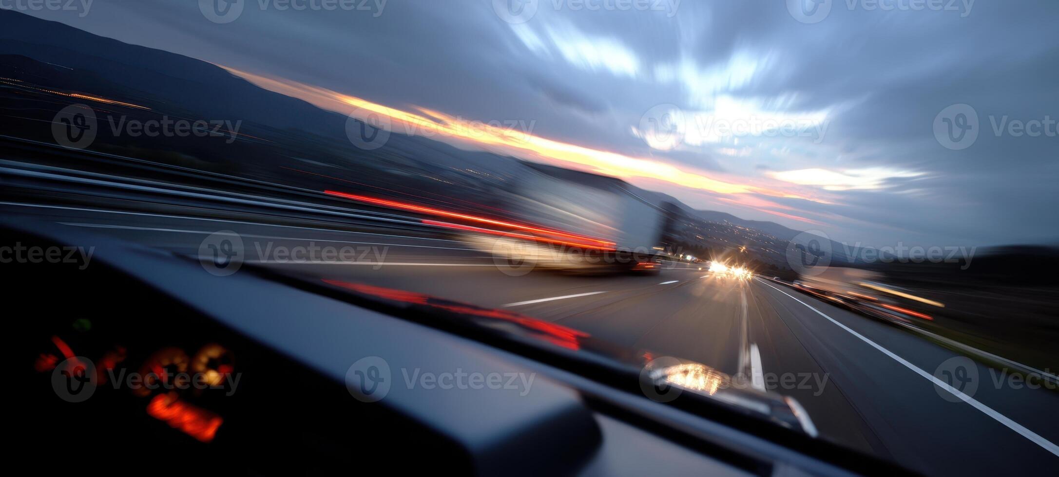 The dynamic journey of a vehicle speeding along a highway at sunset. photo