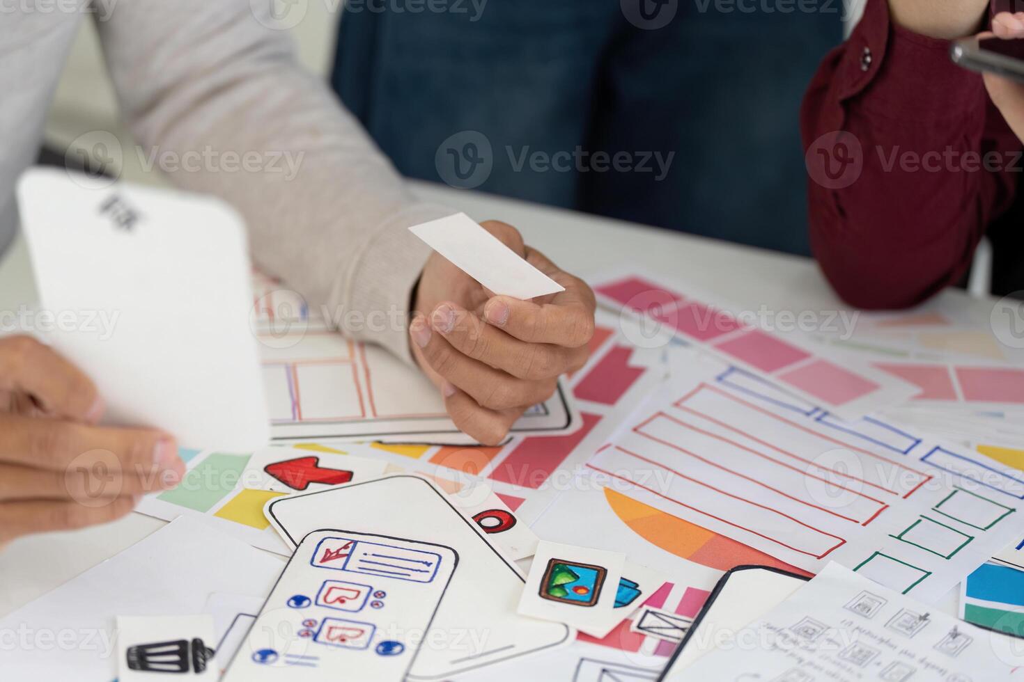 UX and UI Design Process. Team analyzing wireframes and mobile app concepts. photo