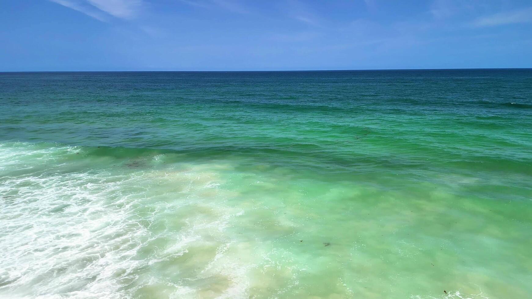 Experience a Serene Coastal View featuring Turquoise Waters and Gentle, Relaxing Waves photo