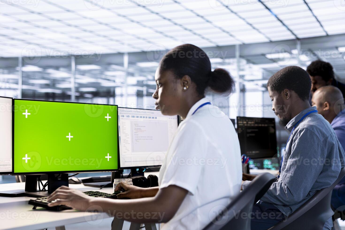 Woman in data center updating systems on isolated screen PC to protect servers from exploitable software vulnerabilities. African american IT specialist using mockup computer to look for errors photo