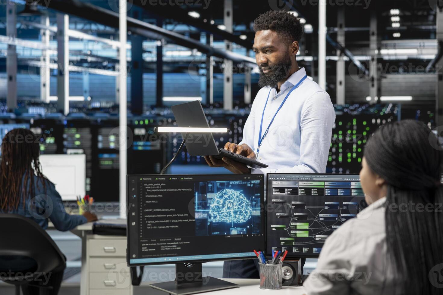 Data center programmer using artificial intelligence neural networks technology. African american man working in server farm using AI programming language on computer, configuring specialized hardware photo