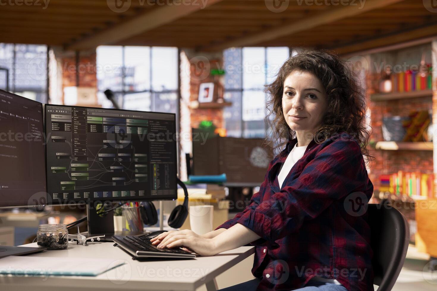 Portrait of smiling programmer coding advanced AI algorithm in startup workspace, refining machine learning models to enhance automation. Happy woman using coding platform in Silicon Valley office photo