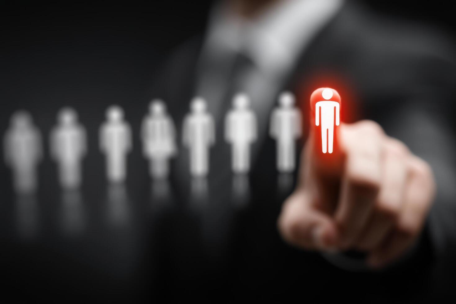 A person is pointing at a person with a red light photo