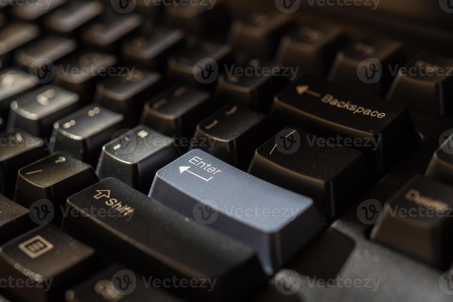 A close up of a computer keyboard with a blue button photo