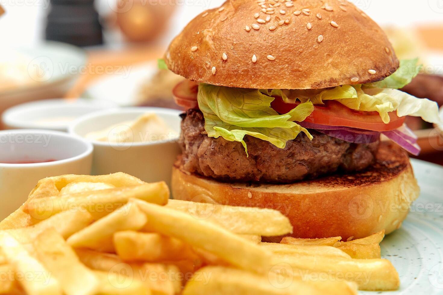 Deliciously Assembled Hamburger with Fresh Vegetables and Crispy French Fries Served on a Plate for a Satisfying Meal Experience 68903179 Stock Photo at Vecteezy