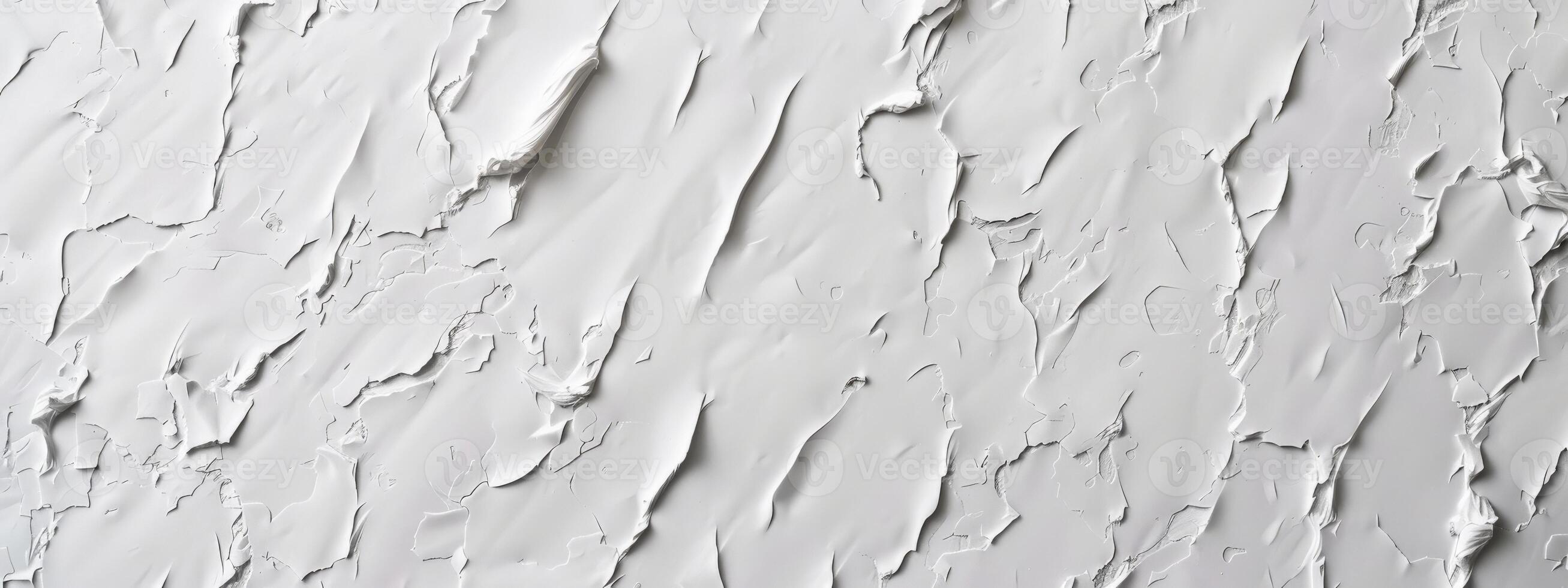 wall is covered in cracks and holes, giving it a rough and unfinished appearance. The texture of the wall is uneven and jagged, with no clear pattern or design. Scene is one of neglect and decay photo