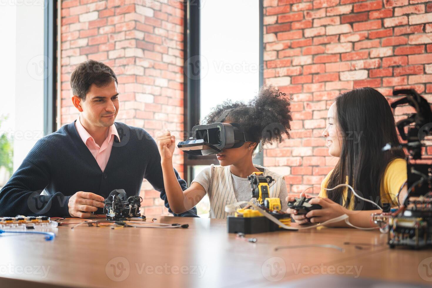 Students and Teacher Exploring Robotics and VR in STEM Class, Kids Learning with Virtual Reality and Engineering Kits, Innovative Education photo