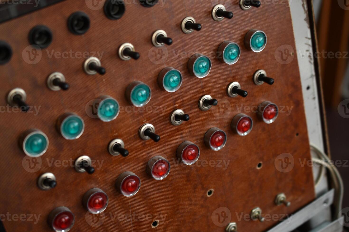 Retro control console with buttons and voltmeter. Panel used in analog signal processing and monitoring. photo