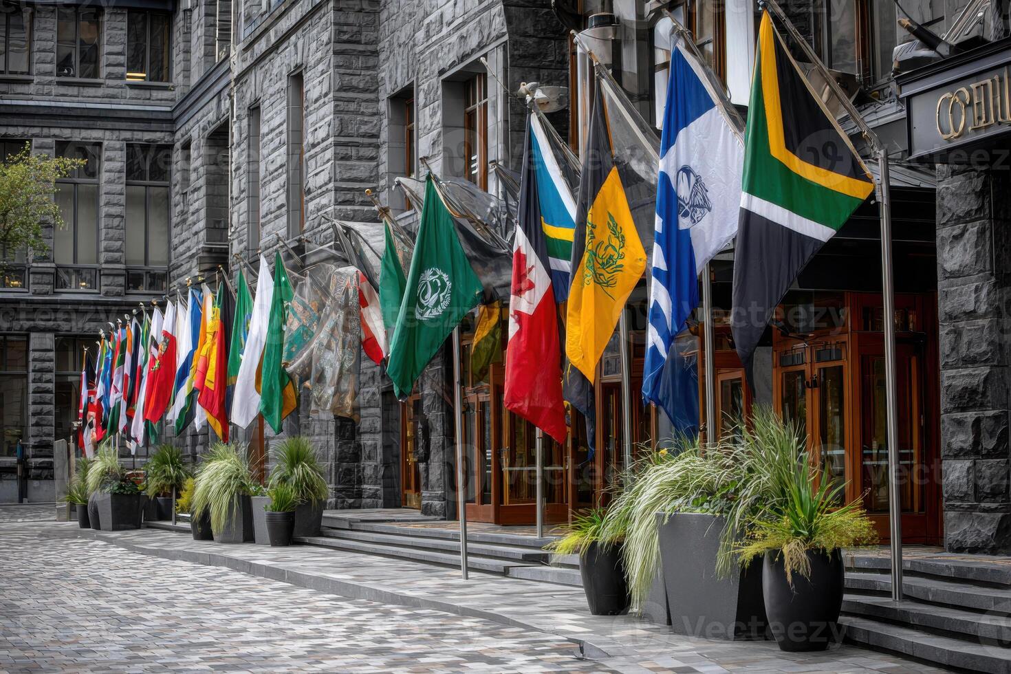 flags of multiple nations outside a modern building