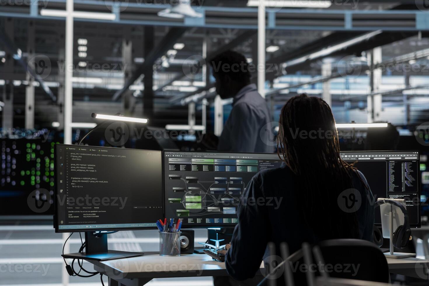 System administrator in data center uses AI technology for machine learning workloads. IT professional in server farm facility using artificial intelligence to perform demanding computing tasks. photo