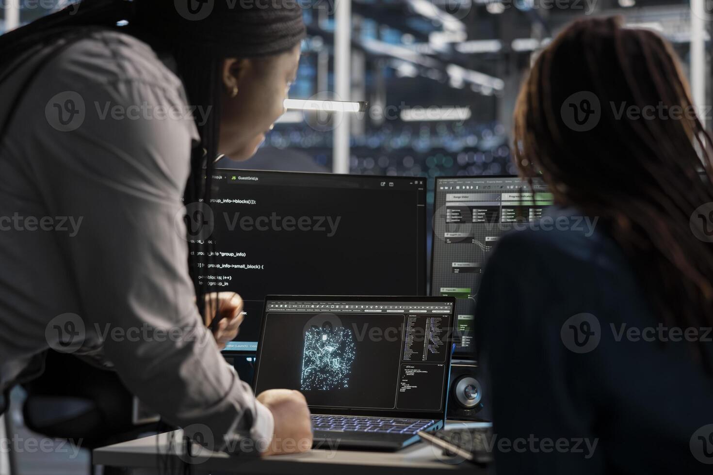 Data center engineering team using artificial intelligence visualization tools on device to identify errors. Teamworking server hub colleagues look at insights to detect hardware failures photo
