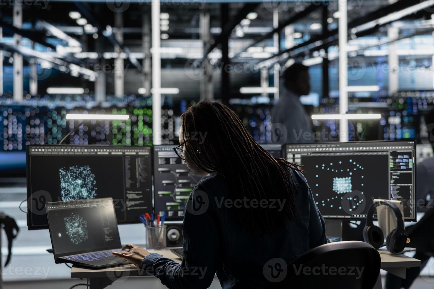 Data center system administrator uses AI visualization tool to optimize resource allocation. Server farm staff member uses artificial intelligence analysis software on computer to do maintenance photo