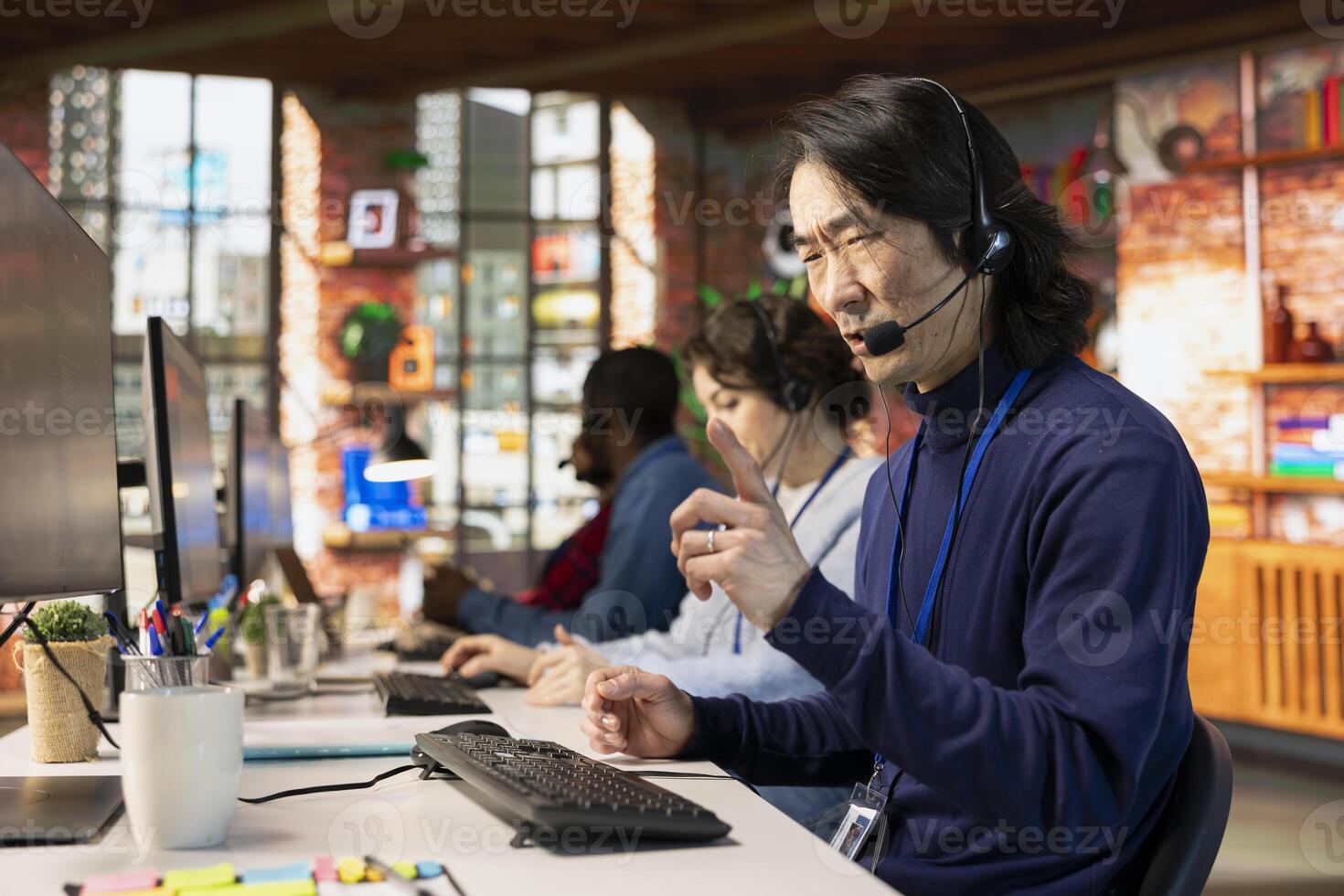 Angry call center agent in office fighting with rude customer complaining during call. Irked customer service representative berating unfriendly client having issues related to services photo