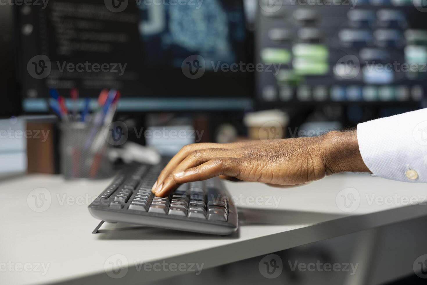 Close up of engineer typing on keyboard, doing maintenance on server hub to optimize it for artificial intelligence workloads. Technician using PC, inspecting neural network data center photo