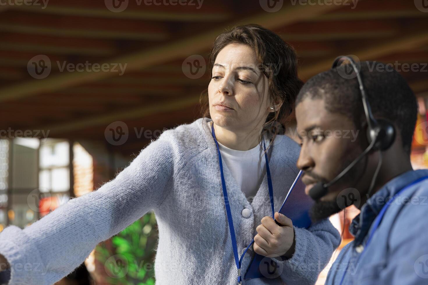 Call center onboarding specialist training staff member on how to use computer software. Close up of supervisor in customer support department office showing intern how to use company programs photo