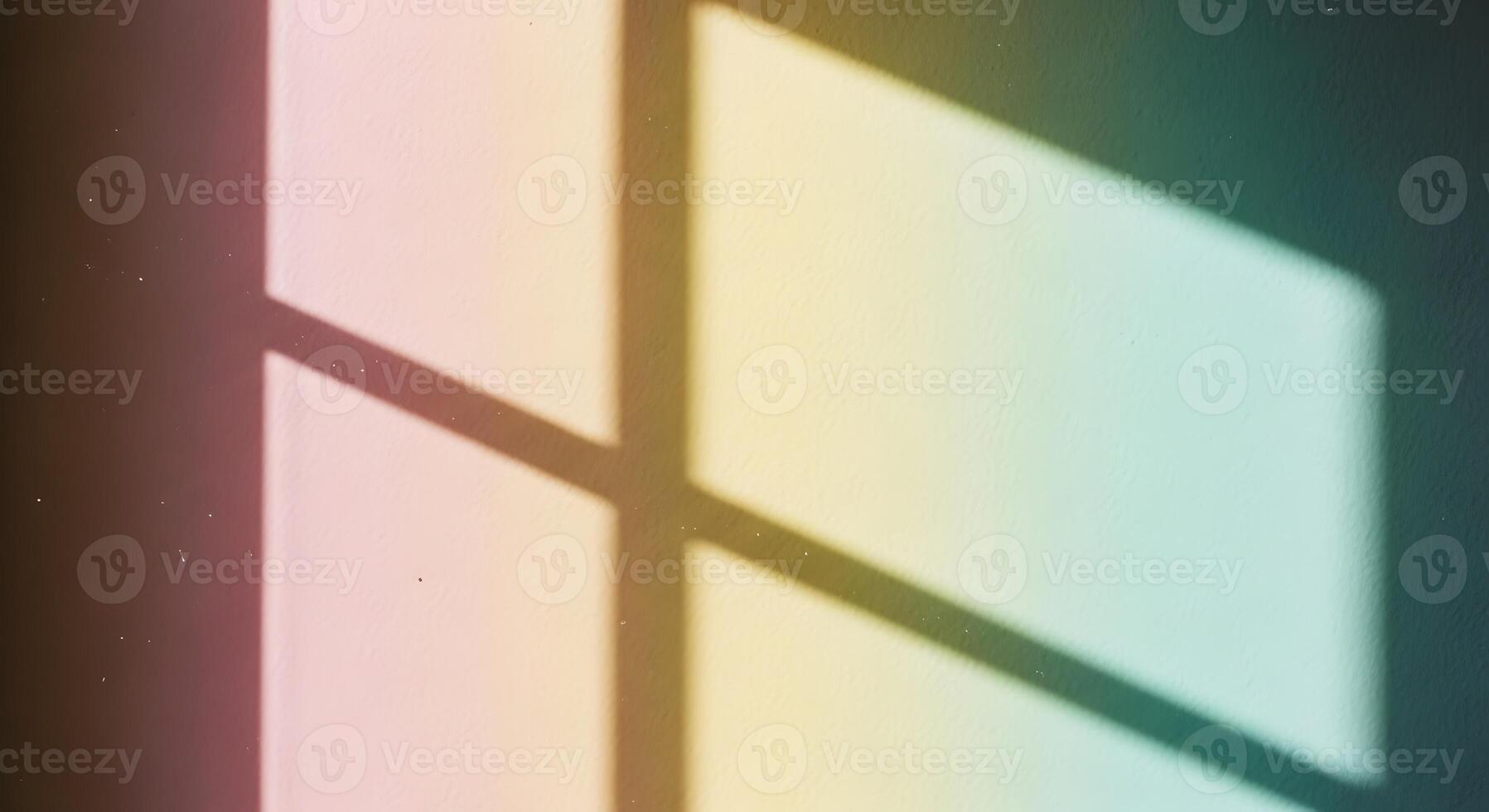 Soft rainbow colored light patterns cast by a window onto a dark background creating a gentle abstract design photo