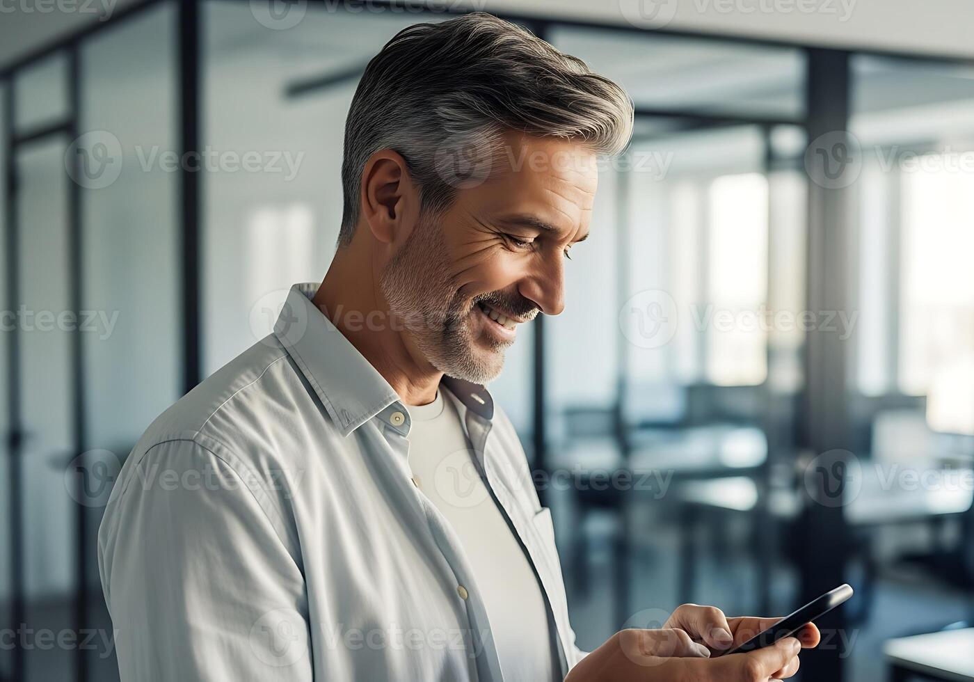 Attractive Mature Businessman Smiling While Using Smartphone in Modern Office Connecting with Technology and Enjoying Digital Communication at Work photo
