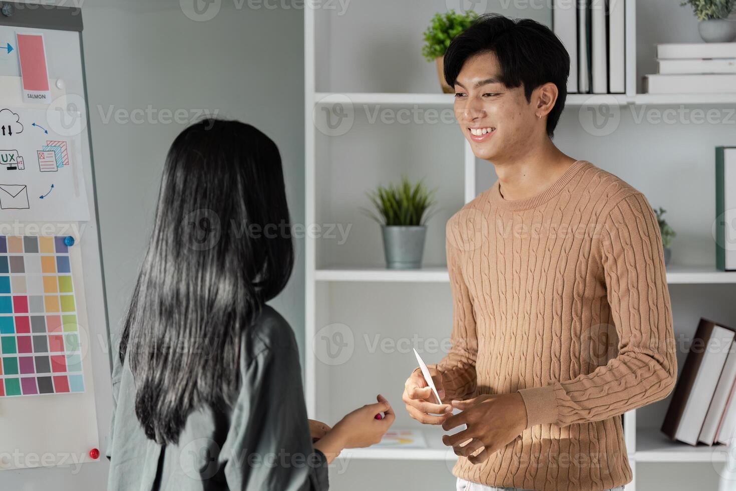 Young Professionals Discussing UX UI Design Concepts in a Modern Office Setting with Creative Business Elements photo