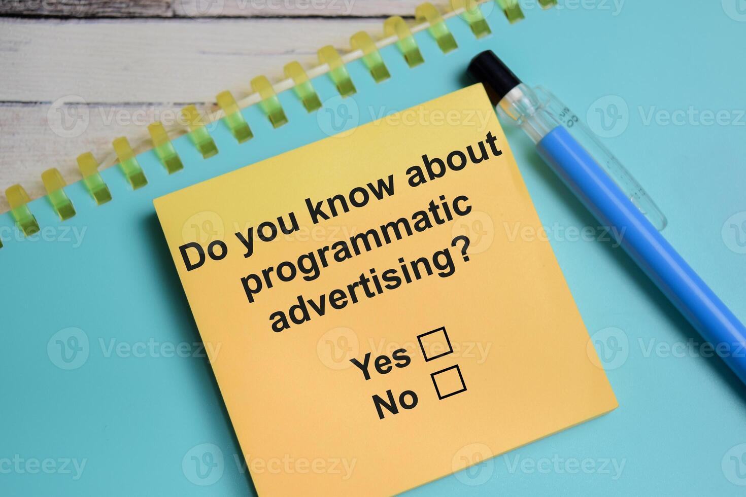 Do you know about programmatic advetising write on sticky notes isolated on Wooden Table. A person is answering question concept photo